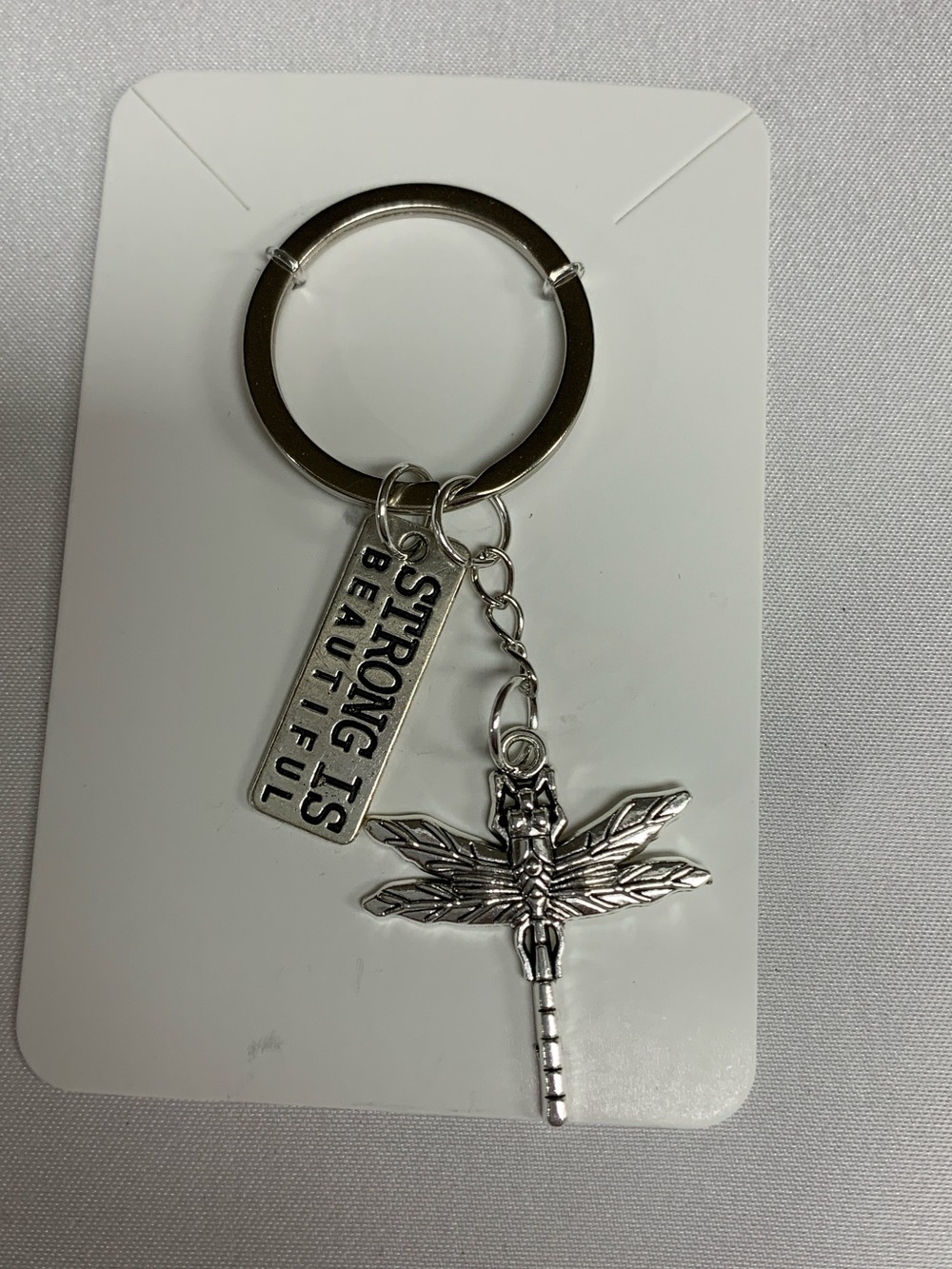 Silver Dragonfly Keychain with "Strong Is Beautiful" Tag